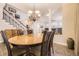 Dining area with a chandelier and views into the living room and staircase at 4396 S Quail Way, Littleton, CO 80127