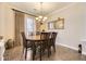 Elegant dining room with a chandelier, wood table, and neutral decor at 4396 S Quail Way, Littleton, CO 80127