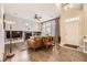 Open-concept living area with tile floors, fireplace, and large windows for natural light at 4396 S Quail Way, Littleton, CO 80127