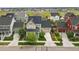 Aerial view of a suburban home featuring solar panels, a two-car garage, and lush landscaping at 6072 Chester St, Denver, CO 80238