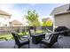 Backyard deck with wicker chairs, a fire pit, and a hammock, creating a relaxing outdoor space at 6072 Chester St, Denver, CO 80238