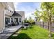 Landscaped backyard featuring a cozy deck, hot tub, and lush lawn, perfect for outdoor enjoyment at 6072 Chester St, Denver, CO 80238