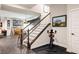 Finished basement entrance with staircase, exercise bike, and decorative wall art at 6072 Chester St, Denver, CO 80238