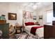 Cozy bedroom with a bed, vintage decor, and decorative paintings at 6072 Chester St, Denver, CO 80238
