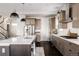 Stylish kitchen with a large island, stainless steel appliances, and hardwood floors at 6072 Chester St, Denver, CO 80238