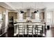 Modern kitchen with a spacious island, stainless steel appliances, and pendant lighting at 6072 Chester St, Denver, CO 80238