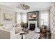 Bright living room with fireplace, ceiling fan, neutral color palette, and large windows at 6072 Chester St, Denver, CO 80238