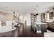 Bright open-concept living space featuring a kitchen, dining area, and staircase at 6072 Chester St, Denver, CO 80238