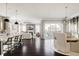 Open concept living space with kitchen island, living room, and dining area at 6072 Chester St, Denver, CO 80238