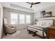 Comfortable main bedroom with lots of natural light, a cozy armchair, and neutral decor at 6072 Chester St, Denver, CO 80238