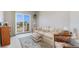 Cozy living room featuring comfortable sofa, bright light from large windows, and sliding glass door at 3337 W 113Th Ave, Westminster, CO 80031