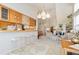 Bright living room with vaulted ceilings, breakfast bar, and open floor plan to adjacent sitting area at 3337 W 113Th Ave, Westminster, CO 80031