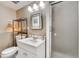 A well-lit bathroom offers a vanity, mirrored cabinet, and a glass-enclosed shower at 8483 Sandreed Cir, Parker, CO 80134