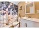 Modern bathroom featuring decorative shower curtain, stylish mirror, white vanity, and neutral wall color at 8483 Sandreed Cir, Parker, CO 80134