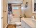 Tiled bathroom featuring a shower with modern curtain and a white vanity with decorative accents at 8483 Sandreed Cir, Parker, CO 80134