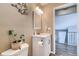 A cozy bathroom features a vanity with storage, neutral walls, and a decorative wall hanging at 8483 Sandreed Cir, Parker, CO 80134