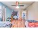 Bedroom featuring wood floors, closet with clothing rack, and ceiling fan at 8483 Sandreed Cir, Parker, CO 80134