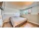 Bedroom featuring window and wood flooring, perfect for relaxation at 8483 Sandreed Cir, Parker, CO 80134