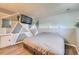 Bedroom featuring wood floors, mounted TV, painted wall, and ample natural light at 8483 Sandreed Cir, Parker, CO 80134