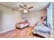 Cozy bedroom featuring two beds with wood floors and decorative stuffed animal storage at 8483 Sandreed Cir, Parker, CO 80134