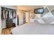 Bedroom featuring closet with clothes, TV mounted to wall with geometric design, and wood flooring at 8483 Sandreed Cir, Parker, CO 80134