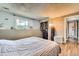 Bedroom with closet, window, and wood flooring, providing a cozy and relaxing atmosphere at 8483 Sandreed Cir, Parker, CO 80134