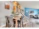 Dining area showing stairs, modern art and decor, and a view into the living room with a fireplace at 8483 Sandreed Cir, Parker, CO 80134