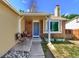 Inviting front porch with brick accents, stylish seating, and a blue entry door at 8483 Sandreed Cir, Parker, CO 80134