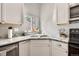 Corner kitchen sink with granite countertops and a window offering natural light and views of the home exterior at 8483 Sandreed Cir, Parker, CO 80134