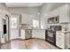 A kitchen area with stainless steel appliances, white cabinets, a window, and a door to the exterior at 8483 Sandreed Cir, Parker, CO 80134