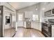 Modern kitchen with stainless steel appliances, granite countertops, and white cabinetry at 8483 Sandreed Cir, Parker, CO 80134