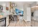 View from kitchen featuring a staircase, living room with fireplace, stainless steel fridge, and dining table at 8483 Sandreed Cir, Parker, CO 80134