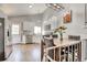 Bright kitchen with stainless steel appliances, white cabinetry, view of stairs, and a dining area at 8483 Sandreed Cir, Parker, CO 80134