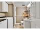 A convenient laundry area also functions as a bathroom, offering efficiency and storage at 8483 Sandreed Cir, Parker, CO 80134