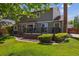 Exterior view of a home with a backyard, deck, and mature landscaping, ideal for outdoor living at 7312 S Moore Ct, Littleton, CO 80127