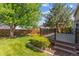 A well-maintained backyard with lush green grass and a composite deck for outdoor enjoyment at 7312 S Moore Ct, Littleton, CO 80127
