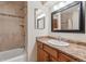 Bathroom with a vanity sink, mirror, and tiled shower-tub combination at 7312 S Moore Ct, Littleton, CO 80127
