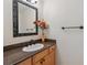 Bathroom featuring a decorative mirror, wood vanity, and floral accents at 7312 S Moore Ct, Littleton, CO 80127