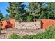Entrance to the Williamsburg II covenant protected community with beautiful flowers and mature trees at 7312 S Moore Ct, Littleton, CO 80127