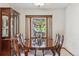 Elegant dining room with a polished wood table, seating for six, and natural light from the window at 7312 S Moore Ct, Littleton, CO 80127