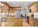 Updated kitchen with stainless steel appliances, custom cabinetry, and hardwood floors at 7312 S Moore Ct, Littleton, CO 80127