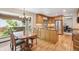 Well-lit kitchen featuring wooden cabinets, granite countertops, and stainless steel appliances at 7312 S Moore Ct, Littleton, CO 80127