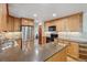 Bright kitchen featuring granite countertops, stainless steel appliances, and light wood cabinetry at 7312 S Moore Ct, Littleton, CO 80127