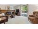 Cozy living room featuring a brick fireplace, plush seating, and natural light at 7312 S Moore Ct, Littleton, CO 80127