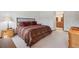Main bedroom with a comfortable bed, side tables, and hardwood floors at 7312 S Moore Ct, Littleton, CO 80127