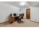 Office with a wooden desk and executive chair, providing a functional and stylish workspace at 7312 S Moore Ct, Littleton, CO 80127