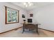 Well-lit office with a view, neutral walls, and a modern desk at 7312 S Moore Ct, Littleton, CO 80127
