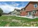 Wide backyard view highlighting the outdoor patio, seating area, fire pit, and lawn space at 9919 Memphis St, Commerce City, CO 80022