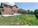 Large backyard with a patio, outdoor seating, and a fire pit offers ample space to relax and play at 9919 Memphis St, Commerce City, CO 80022