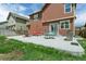 Inviting patio area in the backyard featuring outdoor seating, a grill, and a cozy fire pit at 9919 Memphis St, Commerce City, CO 80022